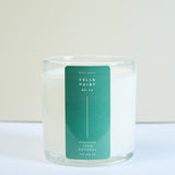 Meet Haus Fells Point soy candle, a Baltimore neighborhood scent: front of the kraft paper tube box, green band reading anchored in port, sharpened in sea salt and dry cedar, natural wax candle, net wt 9 oz.