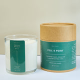 Meet Haus Fells Point soy candle, a Baltimore neighborhood scent: lidless 9 oz glass jar with green label beside its closed kraft tube box reading anchored in port, sharpened in sea salt and dry cedar.